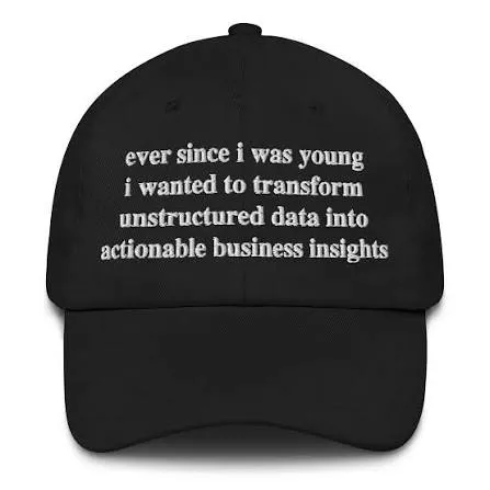 A black dad cap embroidered with "ever since i was young i wanted to transform unstructured data into actionable business insights"